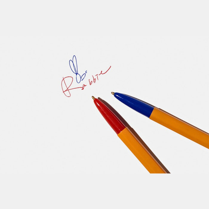 Tools To Live By dual-tip ballpoint pen shown writing on paper.