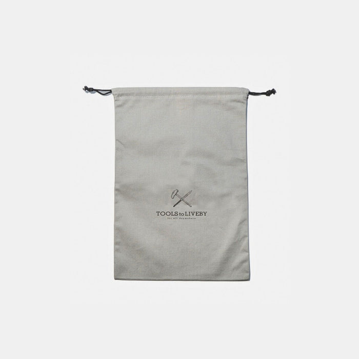 Rear view of grey large Tools To Live By dust bag showing printed logo.