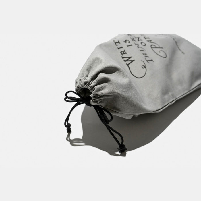 Drawstring closure detail of Tools To Live By grey large dust bag.