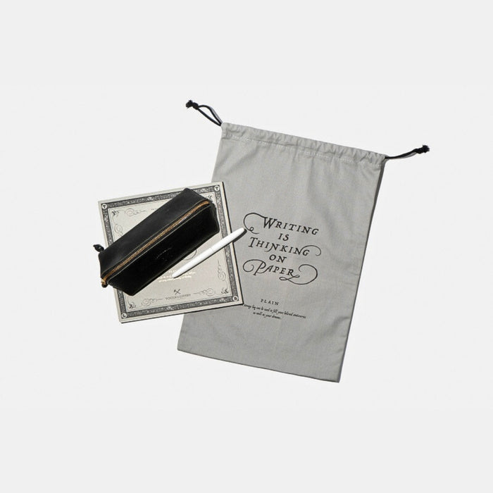 Tools To Live By grey large dust bag beside stationery items.