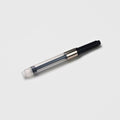 Tools To Live By ink converter shown assembled with clear reservoir and black turning knob on a white background.