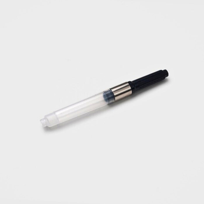 Front view of the Tools To Live By ink converter, highlighting the clear ink chamber and metal connector.