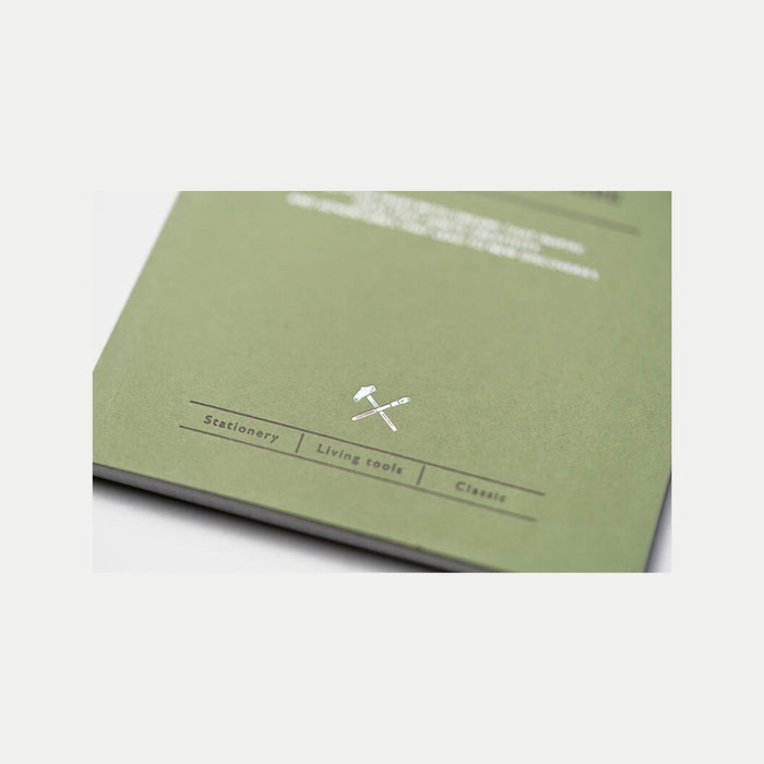 Closed Tools To Live By letterpress machine dot notebook on surface.