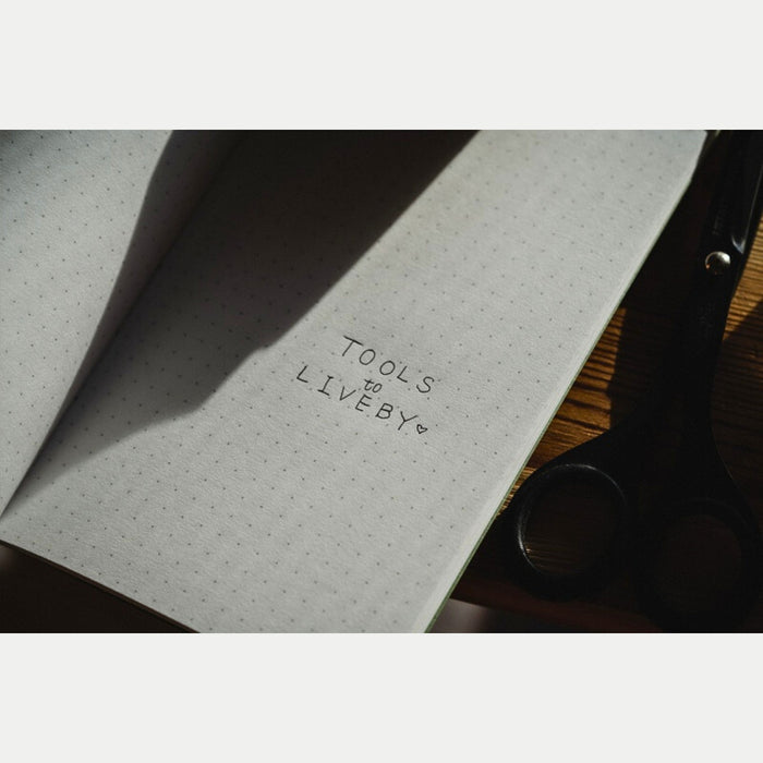 Close-up of interior paper in Tools To Live By letterpress machine dot notebook.