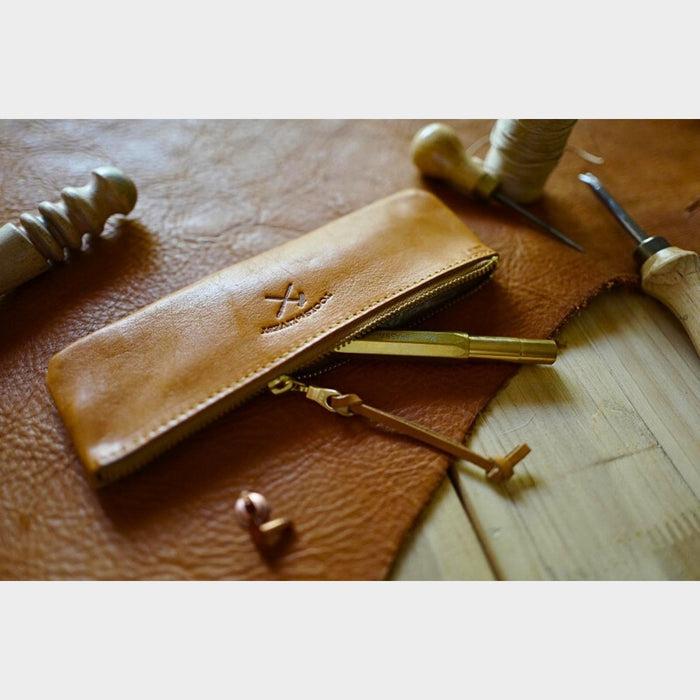 Tan (S) - Close-up detail of the tan leather pen case by Tools To Live By showing texture and stitching.