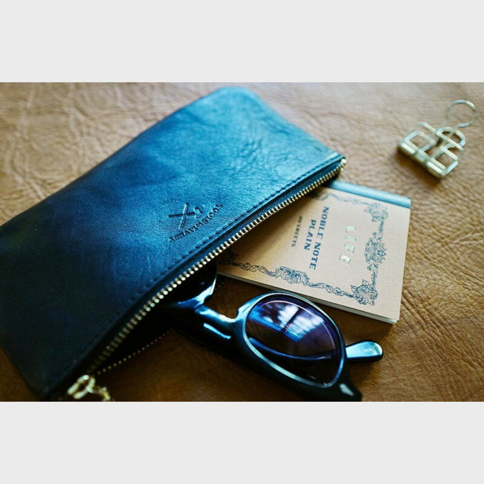 Black (M) - Leather pen case by Tools To Live By styled with notebooks and glasses on a work surface.