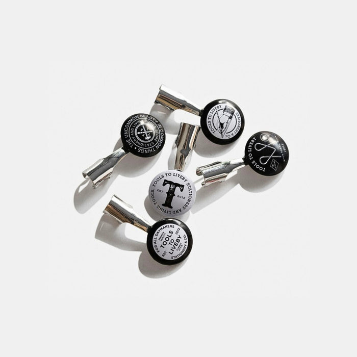 Set of five Tools To Live By pencil topper pocket clips in metal finish.
