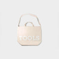 Beige Tools To Live By canvas tote bag shown from the front.