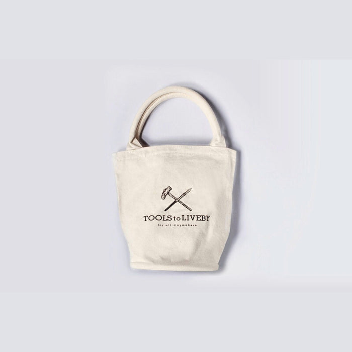 Cream Tools To Live By canvas tote bag with short handles, front view on a white background.