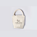 Cream Tools To Live By canvas tote bag with short handles, front view on a white background.