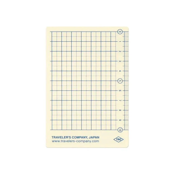 Reverse side of Traveler’s Notebook Passport Size Plastic Sheet 2026 Edition featuring a handy grid layout for writing guides.