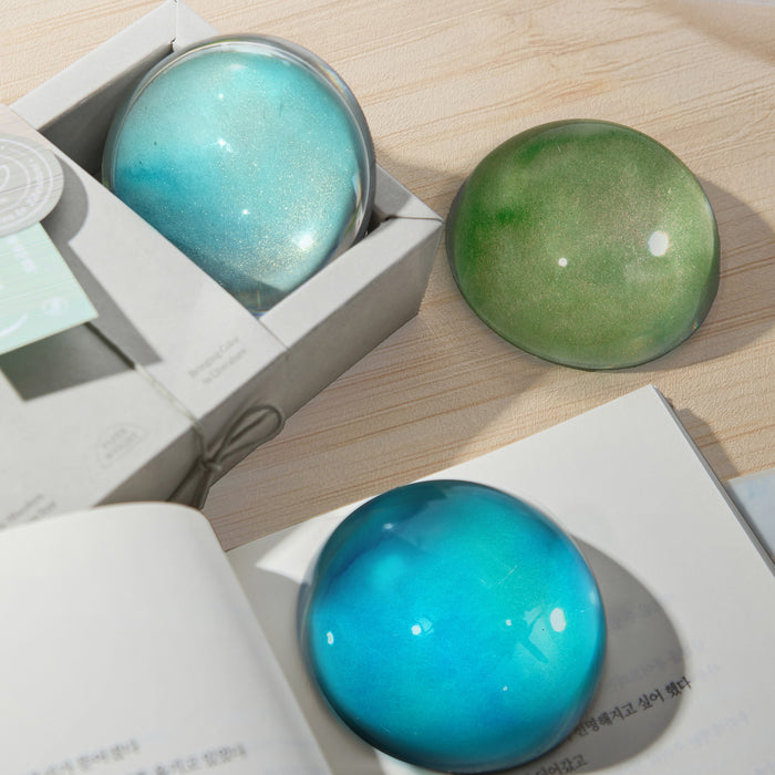 Wearingeul crystal ink paper weights in blue and green displayed in gift box.