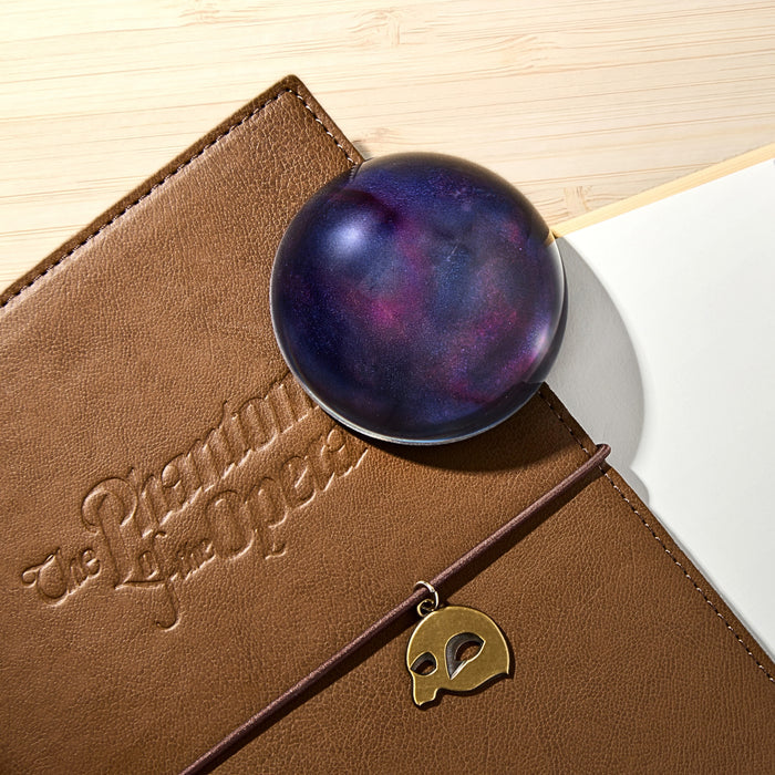 The Phantom of the Opera - Wearingeul crystal ink paper weight resting on a leather diary.