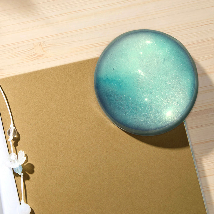Dewy Starlight - Angled view of light blue Wearingeul crystal ink paper weight.