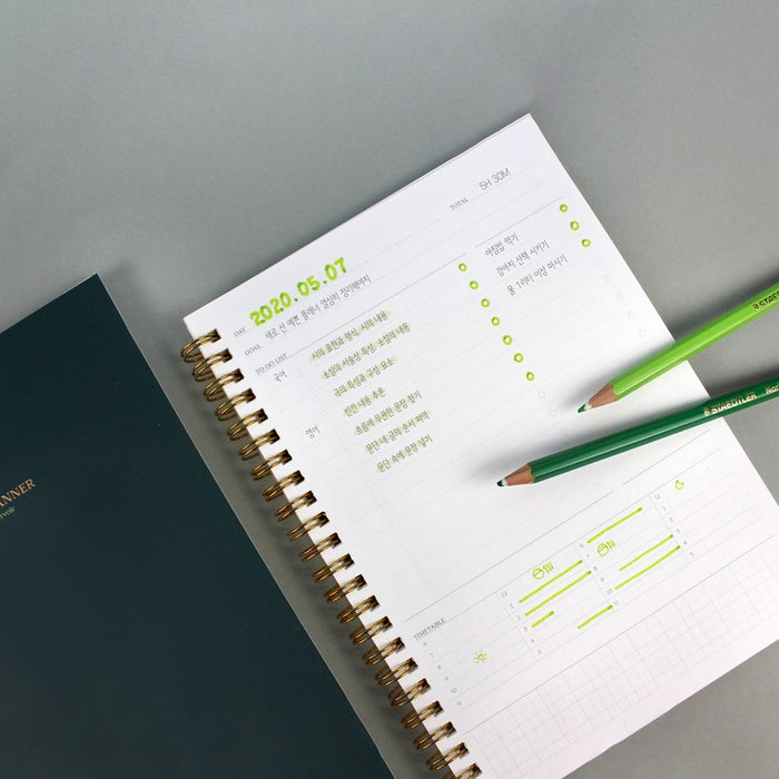 Wearingeul Daily A5 planner open with highlighted entries and pen for planning.