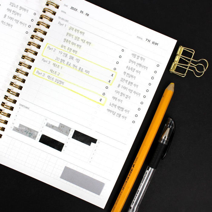 Wearingeul Daily A5 soft cover planner open on desk showing clean page layout.