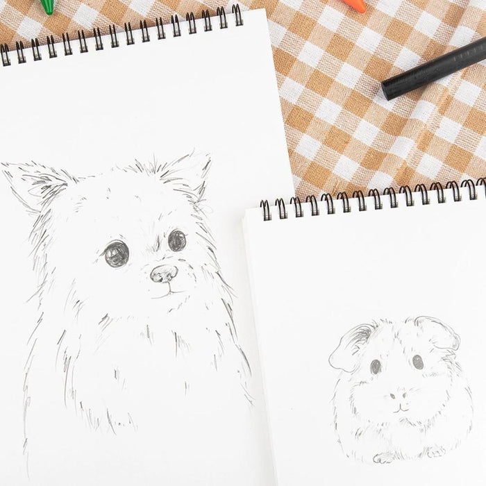 Open Wearingeul Impression Drawing Book with pencil sketches and spiral binding.