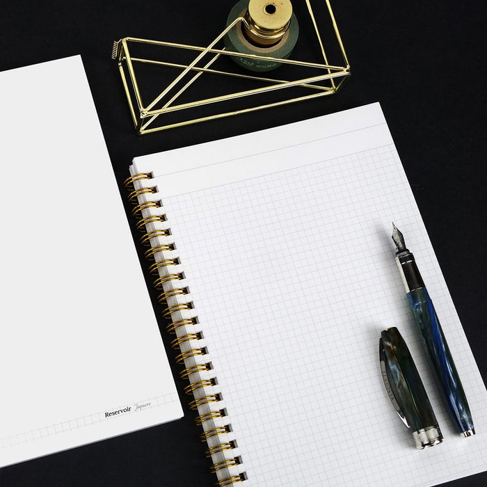 Wearingeul Reservoir Ring Notebook A5 with 4mm grid pages open on desk with fountain pen.