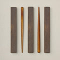 Wearingeul wooden dip pen holders arranged with protective wooden rests.