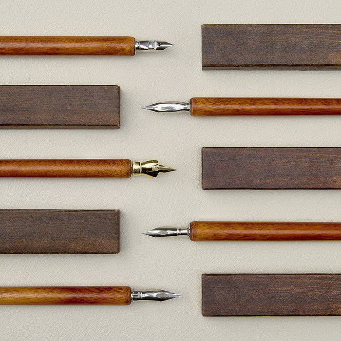 Wearingeul wooden dip pen holder components laid out on surface.