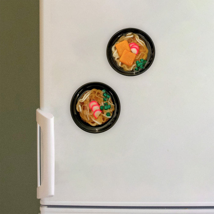 World Craft miniature food sample magnets displayed on a metal surface like a fridge door.