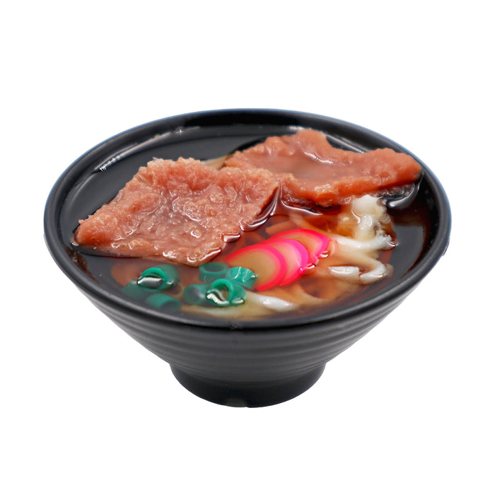 Miniature food sample magnet showing a Japanese noodle bowl topped with sliced meat.